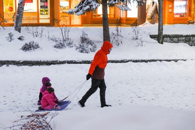 Parent looking stressed with coffee cup on snowy morning